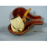 Carved meerschaum and Amber smokers pipe in an Eagle Claw design. In original fitted case