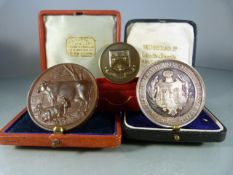 Two medals/medallions to include: Clifton College boxed medal "spiritus intus alit"; A Bronze