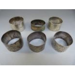 Five various hallmarked silver napkin rings and one other - Total Weight 147g