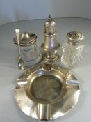 Silver ashtray, silver topped salt pot with silver spoon, silver pepper shaker and salt shaker.