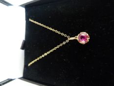 9ct Gold Ruby solitaire pendant hung on a 16" chain. The claw set Ruby measures 5.3mm in diameter