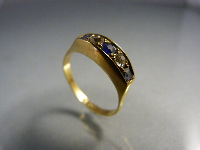 18ct Gold boat shaped sapphire and diamond ring. Centre sapphire approx 3.25mm in diameter with a