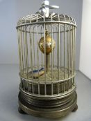 A 20th Century brass automata clock in the form of a bird cage with ticking bird