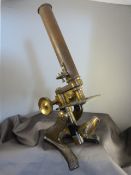 Antique metal and brass microscope,with a box of glass slides, one of which contains a sample of