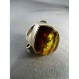 Contemporary silver ring set with an amber stone (surface blemished). UK - N USA - 6.5 Approx weight
