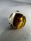 Contemporary silver ring set with an amber stone (surface blemished). UK - N USA - 6.5 Approx weight