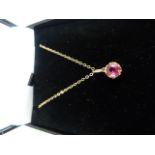 9ct Gold Ruby solitaire pendant hung on a 16" chain. The claw set Ruby measures 5.3mm in diameter