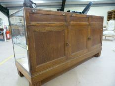 1930's Oak framed haberdashery counter brass banding to corners, with parquet detailing to base