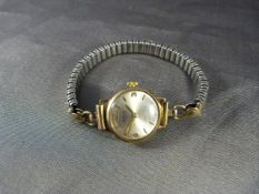 9ct Gold cased cocktail watch by 'Avia' on an expanding Gold Filled bracelet. Stamped 375 to outer