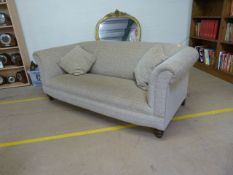 Modern large two seater deep sofa upholstered in beige and green fabric