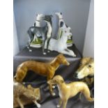 Six figures of greyhounds all unmarked along with a pair of black and white Staffordshire greyhounds