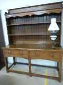 18th/19th Century oak dresser with two tier plate rack, above another ornamental Pot Shelf. Below,