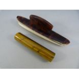 Tortoise shell nail buffer and a circular stem of Tiger's Eye