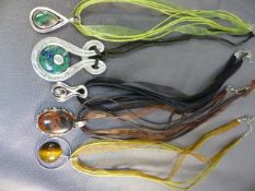 Various silver pendants on ribbon along with one other on cord - (St Justin pewter pendant)