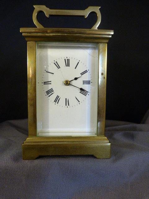 French brass carriage clock with white enamelled dial and Roman Numerals, Chiming action works on