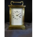 French brass carriage clock with white enamelled dial and Roman Numerals, Chiming action works on