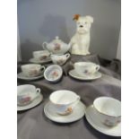 Beswick seated puppy and a miniature dolls house tea set