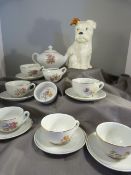 Beswick seated puppy and a miniature dolls house tea set