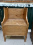 Antique Pine commode with high seated back and campaign style brass handles