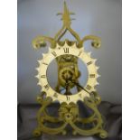 Brass Single fusee movement Skeleton clock. The 16cm dial having Roman Numeral chapters below sat on