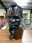 Carved mahogany bust of a Tribal man - intricate detailing of a man smoking a pipe. Black pen