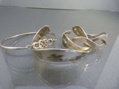 Three contemporary silver bangles