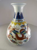 A Chinese vase depicting two dragons in clouds. Above is a collar of Imperial Yellow and