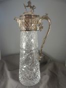 Moulded glass Claret jug of tapering form with unmarked white metal top with Repousse decoration