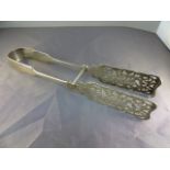 Pair of hallmarked silver tongs with pieced decoration to the spatulas - Sliding action pin in the