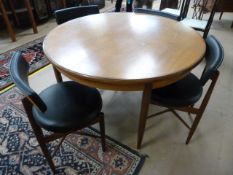 Four round seated black upholstered G-Plan chairs with matching table