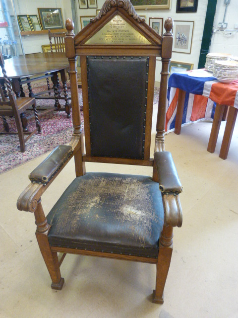 Heavy carved Oak framed Lodge chair with leather arms and seat padded with horse hair. Brass
