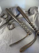 Two police truncheons, one stamped 'Devon Constabulary' and a set of police handcuffs