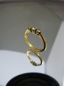 18ct Gold hallmarked ring set with three good diamonds. Middle diamond with fissure to middle and