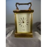 Brass cased carriage clock with five bevelled glass panels made by Fema, London 11 Jewels. White