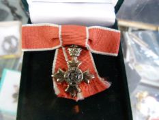 OBE silver medal - boxed in original case with Red Ribbon bow. Made by Toye Kenning and Spencer Ltd