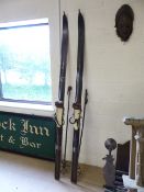 Pair of oak vintage ski's with hand poles. Base to the poles bound by leather C.1900
