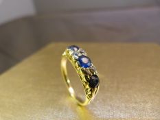 18ct Yellow Gold antique ring set with three large Ceylon sapphires and four diamond chips.