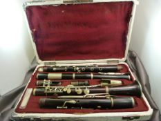 Four Piece Ebonised Rosewood clarinet in fitted case. All parted seem to be present. Stamped '