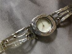 Silver (925) Contemporary watch by JZ. The 'cast' effect bracelet is set with small Garnet stones