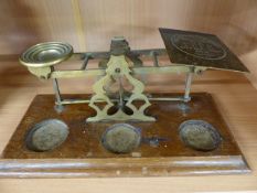 Early 20th Century brass postage scales on oak plinth - missing weights