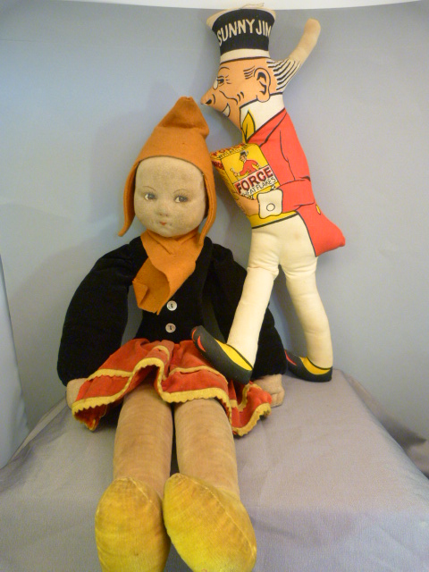 A Nora Wellings Velvet doll. Stylised on a Peasant girl with orange hat and black Jacket. Eyes