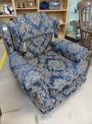 Blue and Gilt coloured upholstered single chair with headrest on wooden legs with castors