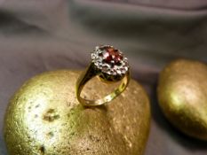 18ct Gold Garnet and diamond cluster ring. The Centre garnet surrounded by small illusion set