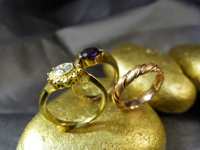 Three Gold on Silver dress rings. (1) Rose coloured Gold of textured and polished twist band