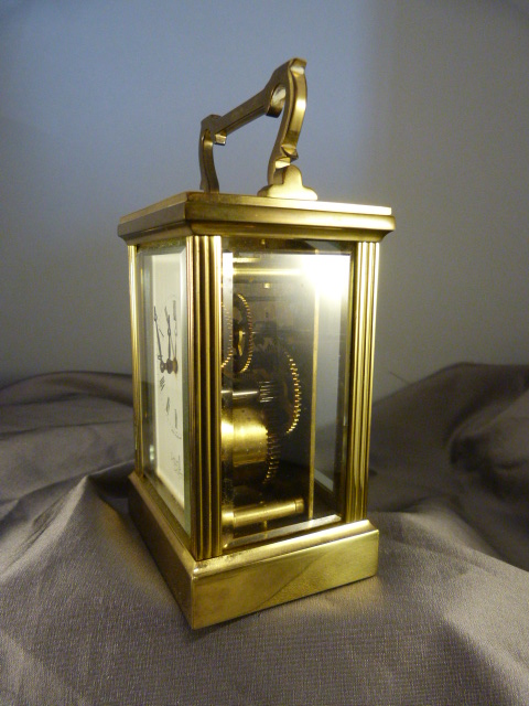 Brass cased carriage clock with five bevelled glass panels made by Fema, London 11 Jewels. White