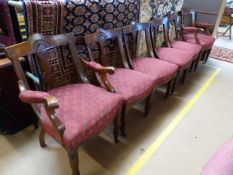 A set of six chunky mahogany framed chairs with red upholstered seats