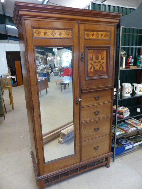 Arts and Crafts inlaid mahogany wardrobe with three graduating drawers below a single cupboard on