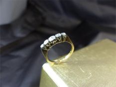 18ct 5 Stone graduated ( approx - 2 x 0.01pts, 2 x 0.02pts and a 0.05 pt stones) Diamond Ring.