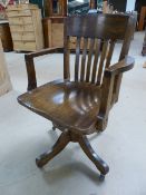 Oak Captains style office chair with original fittings underneath and Vulcanised Rubber