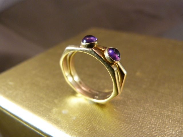 A Pair of 9ct Gold Amethyst set Rings by MG, contemporary design from 1988 meant to be worn